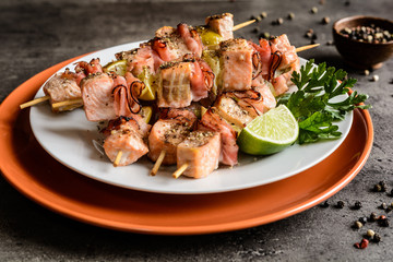 Wall Mural - Roasted salmon skewers with smoked bacon slices and lime