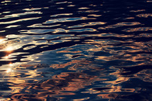 Water Surface With Ripples In Sunset