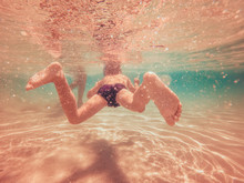  Young Boy Swimming Underwater