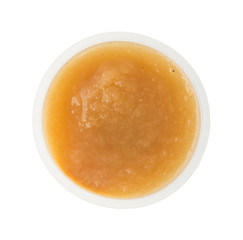 Wall Mural - Cinnamon applesauce in a plastic container on a white background