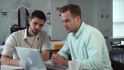 Aufkleber - Business meeting in the modern office. Caucasian professional manager consults mixed race client about services and products company. Smiling men wearing in casual shirt. Young professional workers