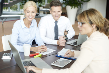 Professional businesswoman and her client. Shot of an insurance agent sitting at office with her client and consulting.