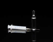  Medical Ampoule And Syringe On A Black Background With Reflecti