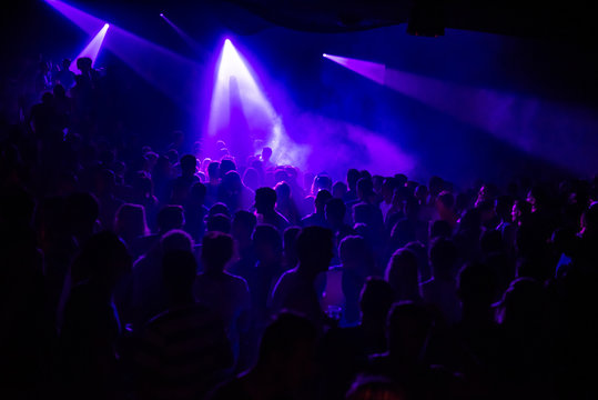 purple lights in a crowded club