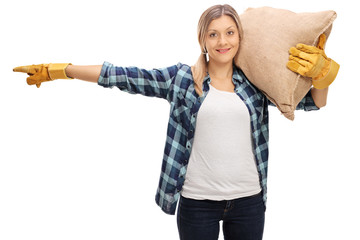 Poster - Female farmer carrying a sack and pointing