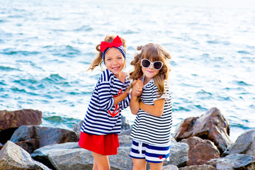 two young girls near the sea rock