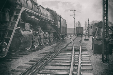 The stylized image of an old steam locomotive at the station