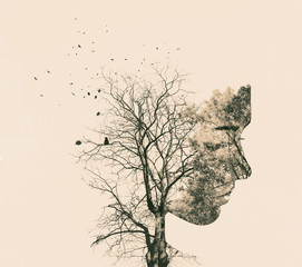 Double exposure portrait of young woman and autumn trees.