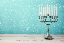 Menorah With Candles For Hanukkah Celebration Over Bokeh Background