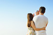 © galina_d - Family portrait. Picture of happy loving father, mother and their baby outdoors. Daddy, mom and child against summer blue sky. Back view.