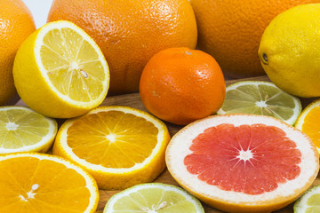 Citrus fruit background with sliced f oranges lemons lime tanger