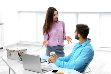 Canvas Print - Beautiful woman and handsome man working in modern office