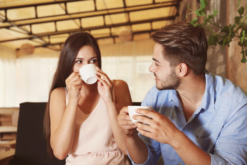 Poster - Beautiful young couple drinking coffee on date