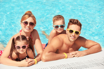 Wall Mural - Happy family in swimming pool at water park