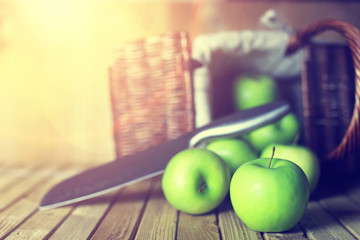 sunlight green apple in a basket wooden background