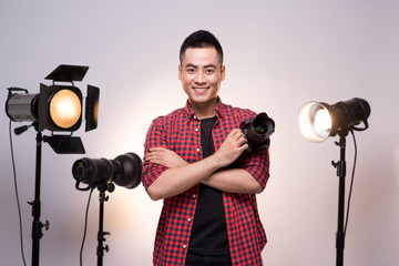 Fototapete - Professional photographer. Portrait of confident young man in sh