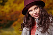 © ZoomTeam - Fashion woman on a background of red and yellow autumn leaves