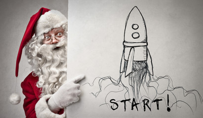 santa claus pointing at a rocket
