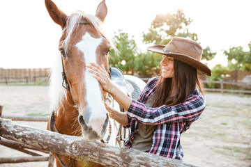 Poster - Happy beautiful young woman with horse standing outdoors