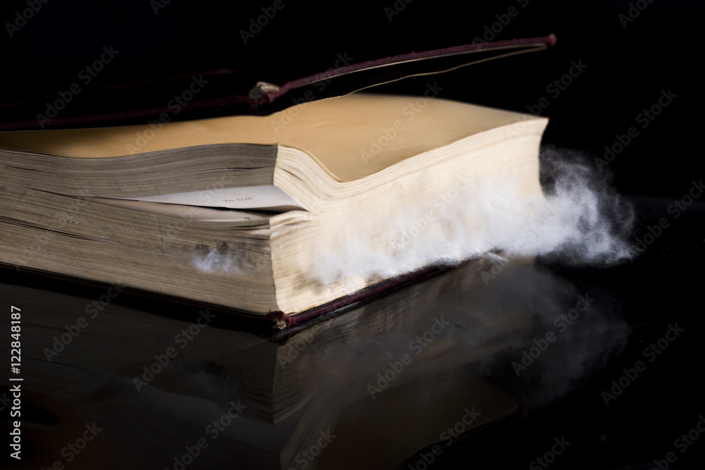 Undusting Book ancient book that while closing brings out a lot of dust Stock Photo ...