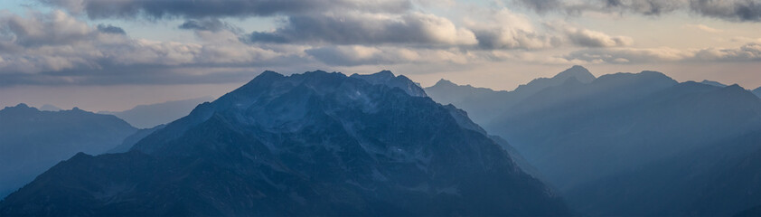 Panorama of mountains in light of evening sun. Greater Caucasus.