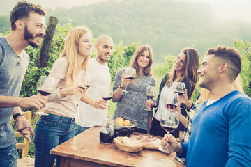 Happy friends having fun outdoor - Young people enjoying harvest time together at farmhouse vineyard countryside - Youth and friendship concept - Shallow depth of field with desaturated vintage filter