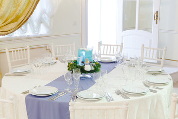 Poster - Round white table served for a festive dinner and decorated in w