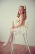 © spass - Pretty smiling ballet girl in white-yellow tutu sitting on chair