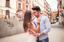 Portrait Of Beautiful Couple In Casual Wear Hugging In The Stree