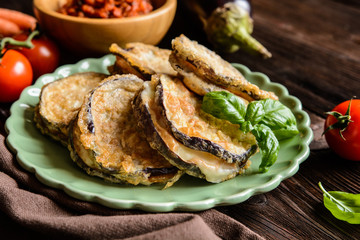 Sticker - Roasted eggplant slices covered in egg, stuffed with Mozzarella, served with tomato salsa