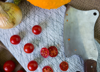 small red cherry tomatoes spill out of on old wooden table in r