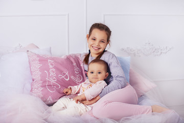sister hugs little sister. the concept of childhood