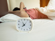 © Kwangmoozaa - white alarm clock and sleeping man