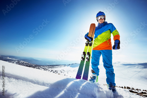 Fotografía Happy skier in colorful clothes with ski