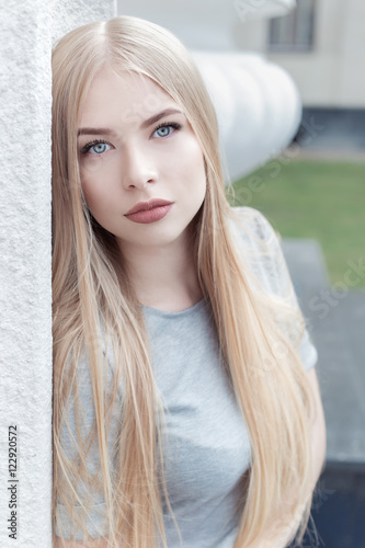 Gentle Portrait Of A Beautiful Cute Girl With Long Blond Hair With