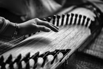 Woman play a traditional korean string instrument : the gayageum