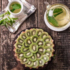 Wall Mural - Tart with kiwi and whipped cream on wooden vintage table