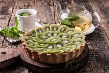 Wall Mural - Tart with kiwi and whipped cream on wooden vintage table