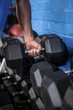 © WavebreakMediaMicro - Man exercising with dumbbell in gym
