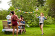 © Syda Productions - happy friends playing badminton at summer garden