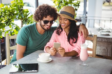 Poster - Couple looking at mobile phone