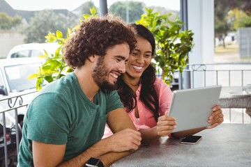 Poster - Couple looking at digital tablet