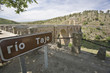 Road sign of Tagus river at Alcantara Roman bridge, Caceres, Spain