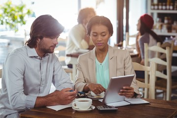 Poster - Man and woman using a digital tablet during meeting 