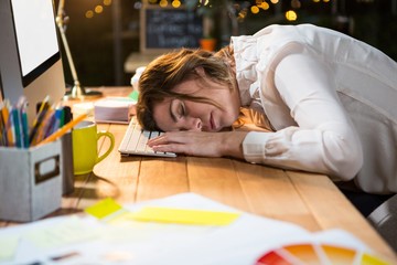 Canvas Print - Tired businesswoman sleeping on the desk