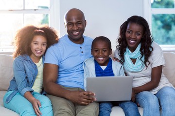 Portrait of family using laptop