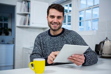 Poster - Man using digital tablet in the kitchen