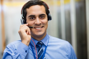 Poster - Portrait of technician talking on head phones