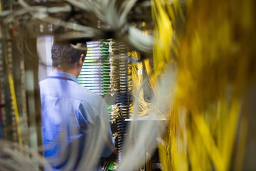 Poster - Technician checking routers