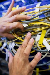 Aufkleber - Technician checking cables in a rack mounted server